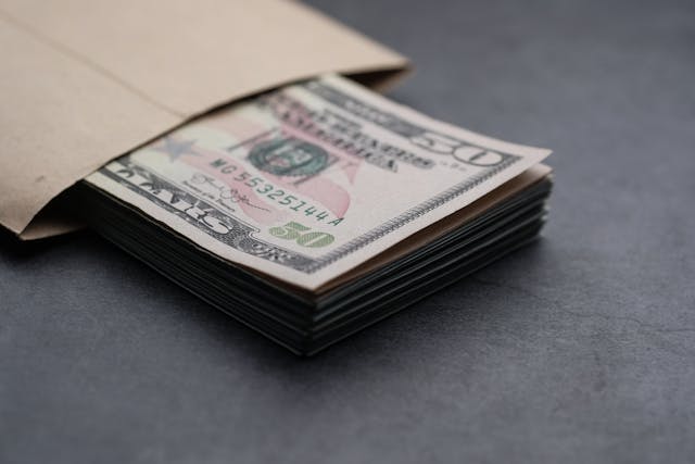 some fifty dollar bills in an envelope